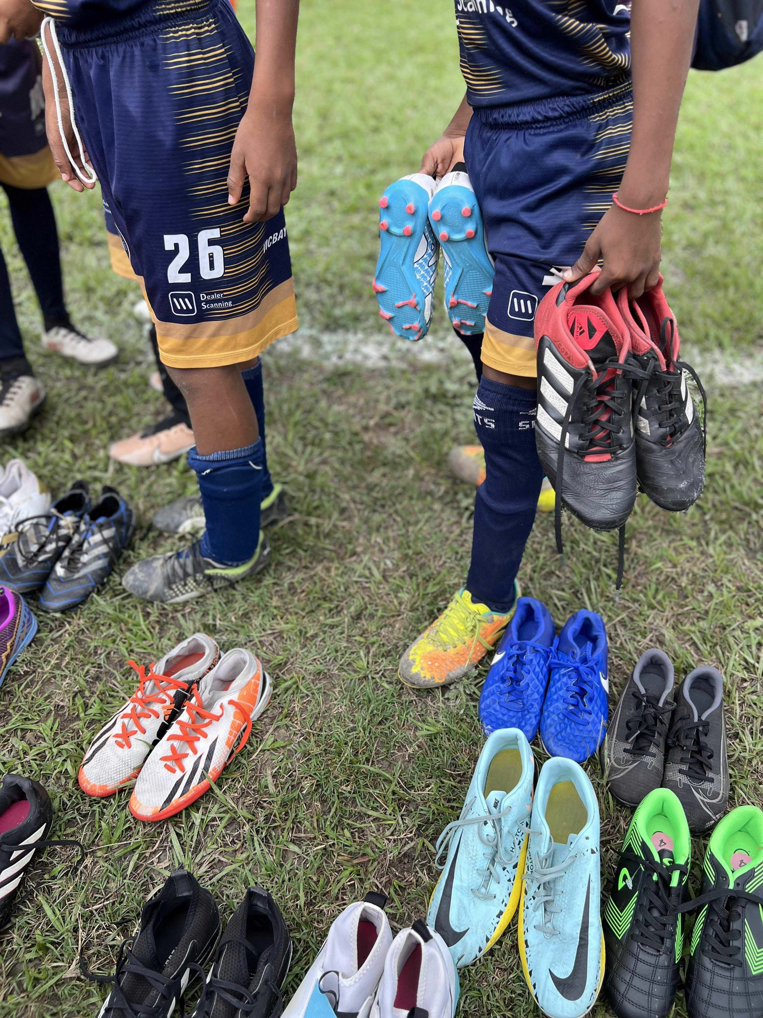 Children receiving cleats in their community